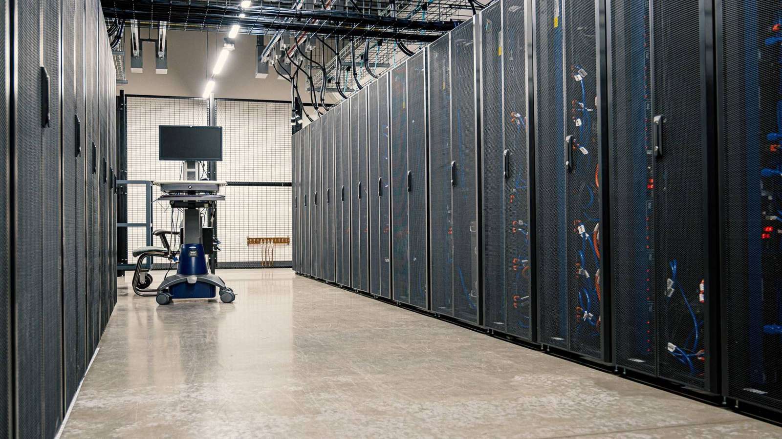 Rows of illuminated server racks in a data center aisle