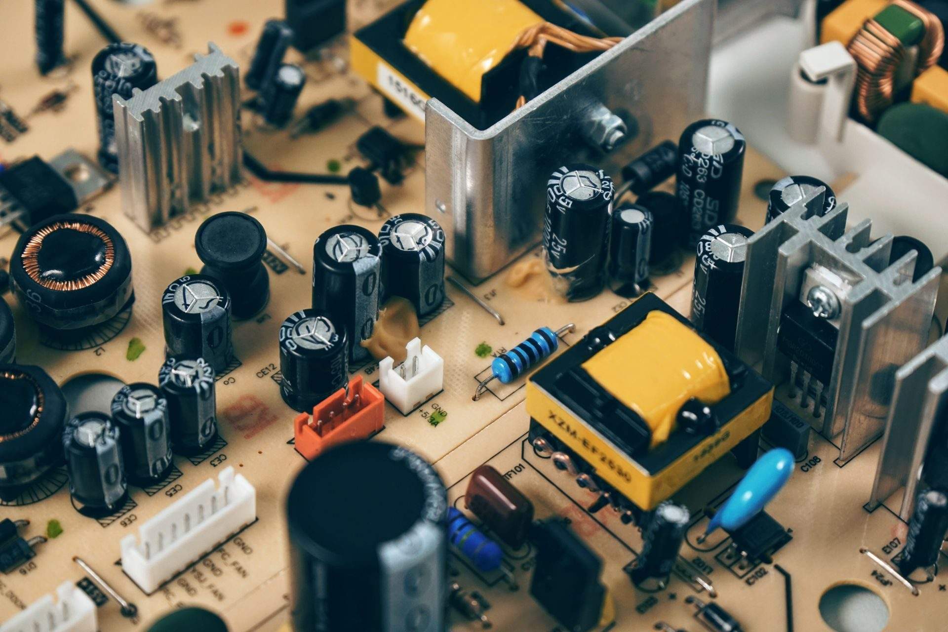Close-up of a green printed circuit board with resistors and copper traces